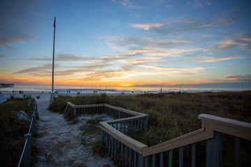 Obraz premium beautiful sunset sky sun going down over panama city beach with silhouettes of people