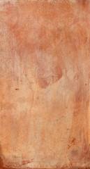 Vertical surface of a wall with a red and orange irregulartexture with beautiful weather marks - wallpaper background