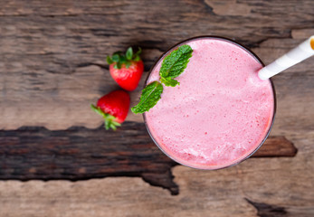 Strawberry smoothies juice beverage healthy the taste yummy In glass drink episode morning on wooden background from the top view.