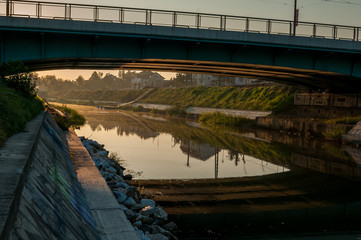 A view of the Bega river early in the morning. Sunrise in the city. Mihai Viteazul bridge.