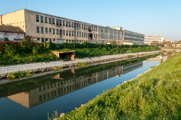 A view of the Bega river early in the morning. Sunrise in the city. The leather and glove factory.