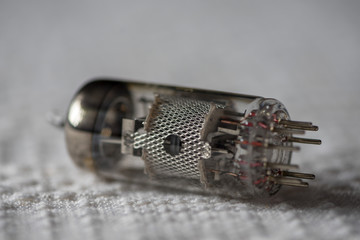 Close-up of a triode from an old TV, laying on a white cloth