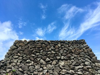 The stone rock with cloud and blue sky landscape on Jeju Korea 