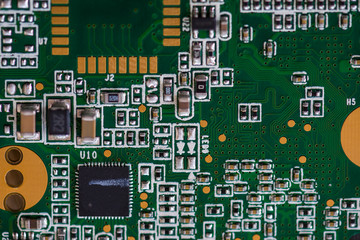 Close-up of an electronic circuit board populated with resistors, capacitors, inductors and integrated circuits.
