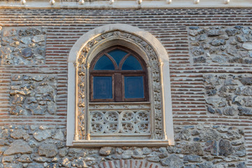 Neo-Gothic window in a brick facade of a religious building in Madrid. Spain.