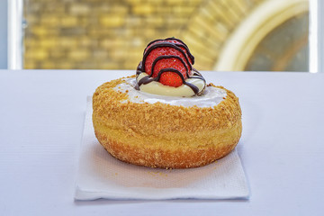 Chocolate-covered donut with strawberry