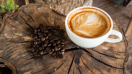 Black coffee cup on old wooden table top view. note book and pencil. lifestyle concept
