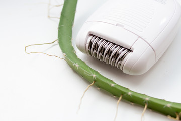 cactus and electric hair removal epilator. Beauty concept