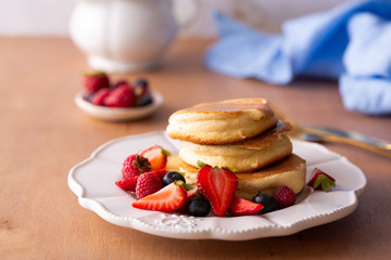 Stack of homemade Japanese fluffy pancakes for breakfast with berries