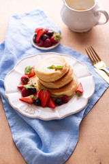 Pile of trendy homemade Japanese fluffy pancakes for breakfast with berries