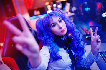 Young woman streamer anime cosplay professional gamer playing video online games computer - obrazy, fototapety, plakaty