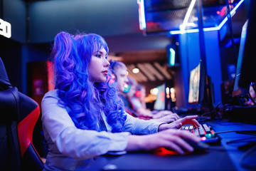 Young woman professional gamer playing winning tournaments online games computer