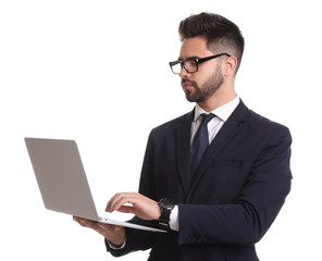 Young businessman with laptop on white background