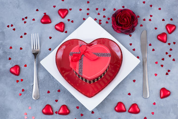 heart shaped plate, cutlery, gift in a box and festive decor