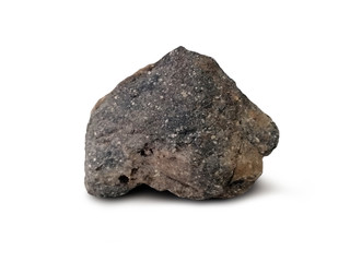 Andesite stone isolated on white background. Andesite is an extrusive igneous rock named after the Andes Mountains where it is very abundant. There is noise and grain caused by the texture of stone.
