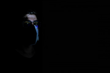 Male introvert character in white mask self-isolating in his dark apartment. Quarantine spooky...