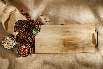 Coffee beans seen from above with light brown beige linen background. Copy space for advertising...