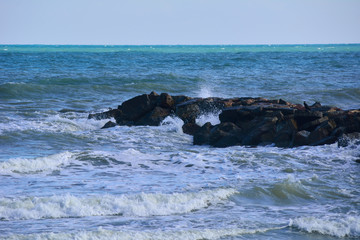 Waves breaking on the rocks of the coast.