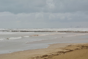 Groyne and port cranes in a big storm.