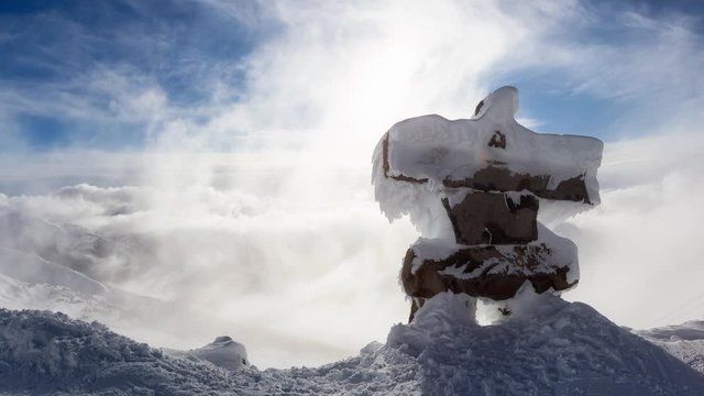 Cinemagraph Continuous Loop Animation. Whistler, British Columbia, Canada. Beautiful View of Statue on top a Mountain with the Canadian Landscape in background during a vibrant winter sunset.