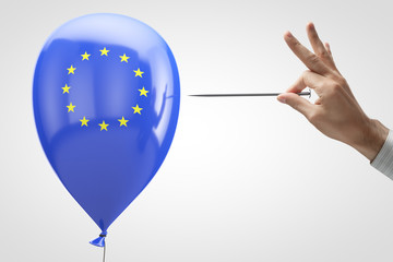 Threat to the European Union. Conceptual photo. Inflatable balloon with the symbol of the European Union and a needle in hand.