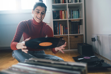 Young woman with her favorite vinyl record 
