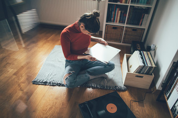 Young woman enjoy her vinyl records collection