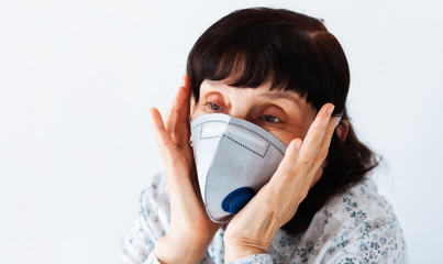 Coronavirus quarantine Covid-19 concept. Face of old sick woman wearing respirator mask for protect. Wuhan, China epidemic virus symptoms background.