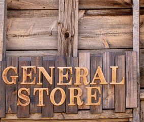 Wooden General Store sign against wooden planks