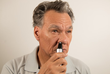 Man Trimming his Nose with a Nose Hair Trimmer