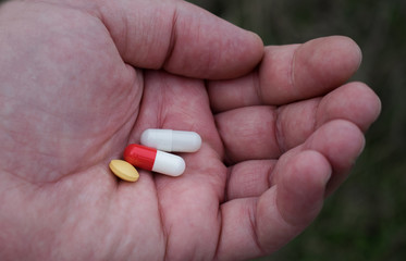 Concept for drug use. Pills held in the palm. Stop drug use Taking Medication health care medical concept.