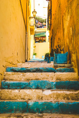 Yellow Walls and Teal Blue Green Stairs on a Small Passage in Alicante Spain