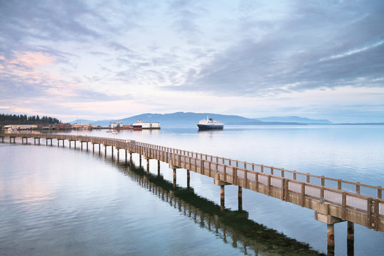 Alaska Ferry approaching dock in Bellingham Bay. from Boulevard Park Boardwalk. Bellingham Washington. Bellingham. Washington. United States