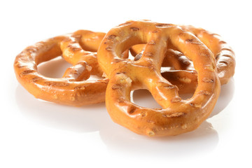 Pretzels, three mini snacks with salt for beer. Savory backed beer snack. Macro close-up isolated on white background, side view