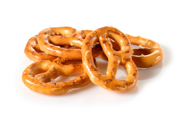 Pretzels, four mini snacks with salt for beer. Savory backed beer snack. Macro close-up isolated on white background, side view