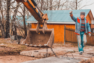 A chain excavator pulls concrete slabs to set the track.