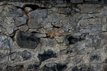 Texture of stone wall made of grey stones