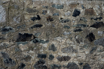 Texture of stone wall made of grey stones