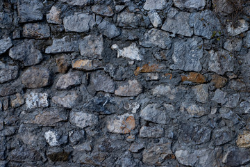 Texture of stone wall made of grey stones