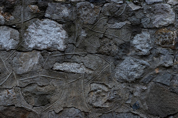 Texture of stone wall made of grey stones