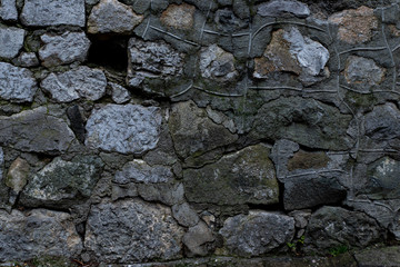 Texture of stone wall made of grey stones