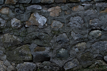 Texture of stone wall made of grey stones