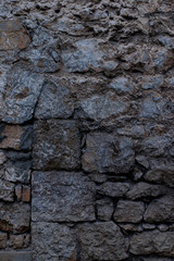 Texture of stone wall made of grey stones