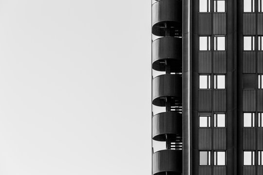 Modern building with abstract design of fire escape stairs in black and white with left negative space