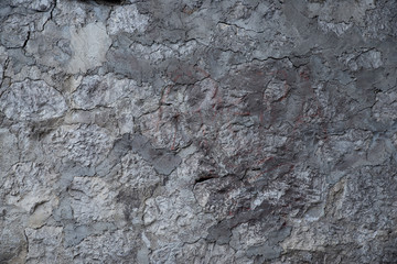 Texture of stone wall made of grey stones
