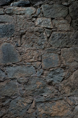 Texture of stone wall made of grey stones