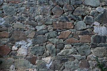 Texture of stone wall made of grey stones