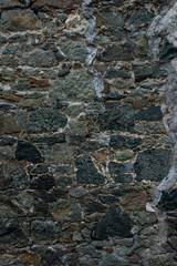 Texture of stone wall made of grey stones