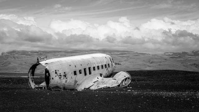 The iconic DC3 airplane wreck on black sand in iceland in black and white