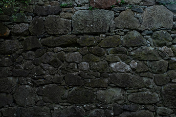 Texture of stone wall made of grey stones